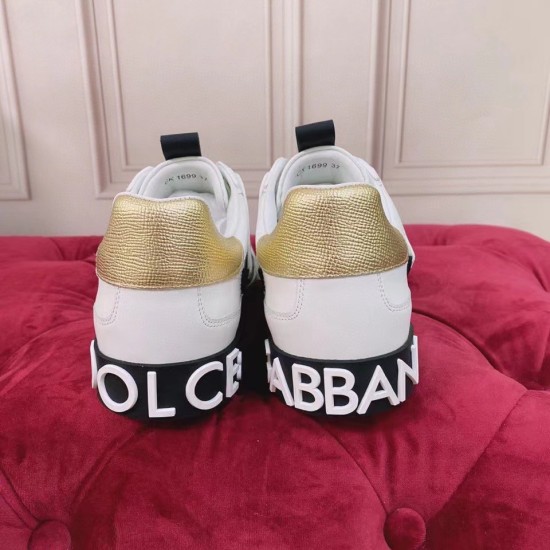 Dolce & Gabbana Custom 2.Zero Trainers Heel View in white and black Rear view showing gold heel tabs and black rubber logo soles of Dolce & Gabbana trainers in white and black