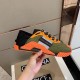 Side profile view of the orange and green Dolce & Gabbana low-top trainer highlighting the sculpted midfoot frame