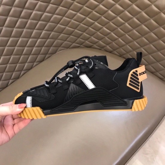 Inner lateral view of Dolce & Gabbana black trainer showing gum tread sole in black and tan