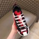 Dolce & Gabbana Red Trainer Overhead Hand View Hand holding Dolce & Gabbana red fabric trainer overhead view showing tongue and laces