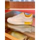 Lateral View of White Leather Portofino Trainer in white and yellow Lateral side view resting on glass surface showing white rubber sole and yellow trim