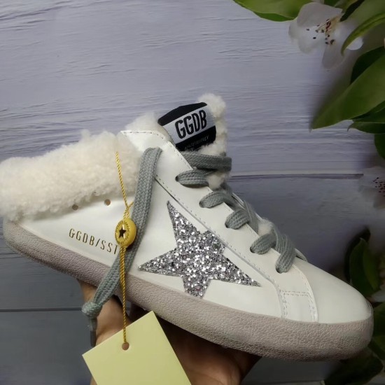Golden Goose Super-Star Sabot Gold Lettering Detail in white Hand holding Golden Goose Super-Star Sabot white trainer displaying gold side lettering