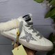 Golden Goose Super-Star Sabot Gold Lettering Detail in white Hand holding Golden Goose Super-Star Sabot white trainer displaying gold side lettering