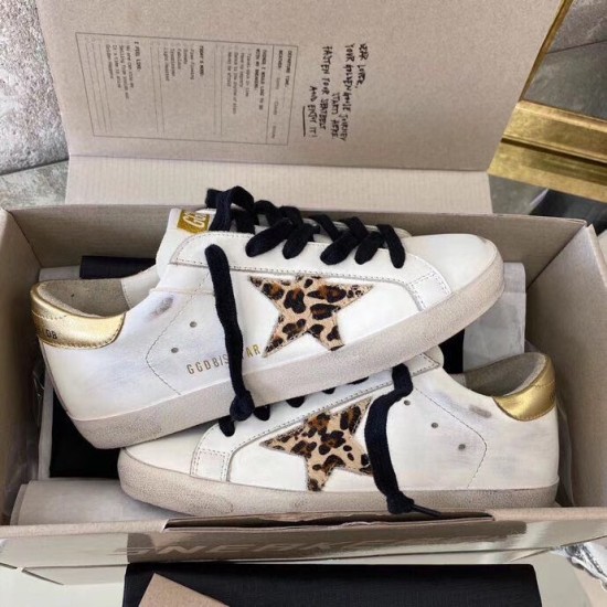 Golden Goose Super-Star Pair in Packaging in white and gold Both Golden Goose white leather trainers displayed together in open presentation box