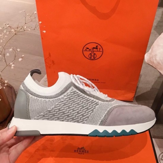 Side profile of the Hermes grey knit trainer showcasing the white midsole and teal accents