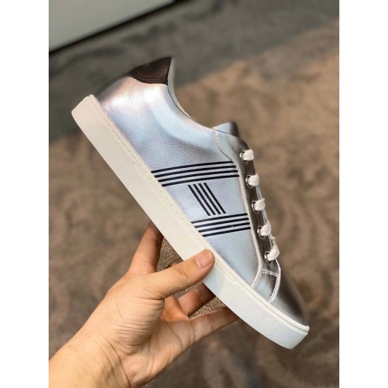 Hermes Avantage Metallic Silver Trainer Side View Side profile view of the metallic silver leather trainer displaying graphic side stripes