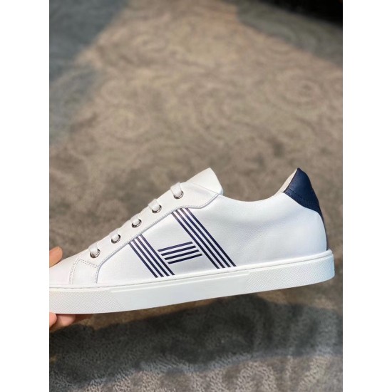 Hermes Avantage Leather Trainers Side Profile in white and blue Side profile of white leather trainer featuring blue striped side accent