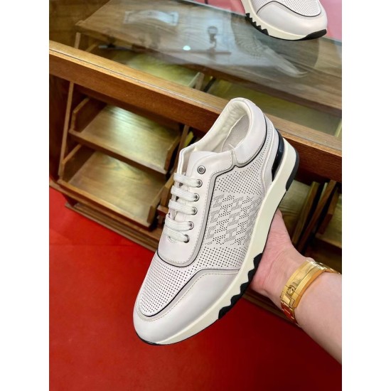 Hermes Addict White Perforated Low Top Trainer Handheld Side Profile Handheld view highlighting the side micro-perforations and contrast trim on the white Hermes Addict trainer