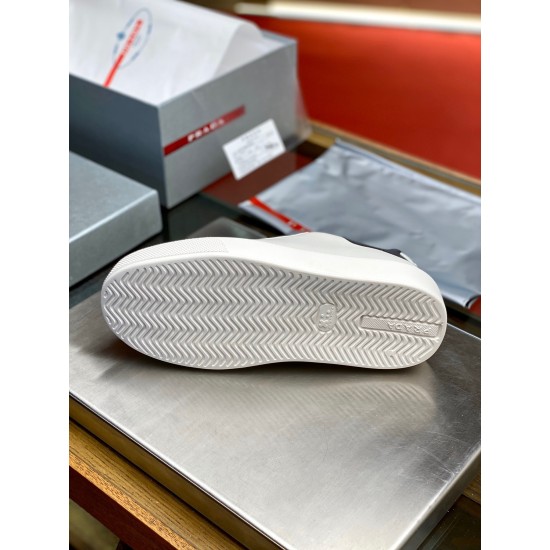 Underneath view of the white zig-zag tread sole on Prada Macro trainers in white and black