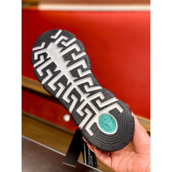Versace Trigreca Black Trainers Sole View in black and yellow Underside view of black and white Greca tread outsole featuring a green Medusa emblem detail in black and yellow