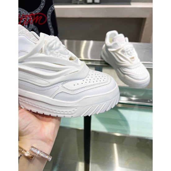Close-up of white leather toe box and Medusa sculpture on Versace trainer
