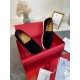 Top-down view of pair of black Christian Louboutin Pik Boat Flat trainers in red presentation box in black and white