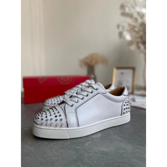 Side profile of Christian Louboutin white spiked leather low-top trainers in white and silver