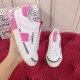 Dolce & Gabbana Custom 2.Zero Trainer In Hand Close-Up in white and pink Hand holding a white and pink Dolce & Gabbana trainer showing side logo patch