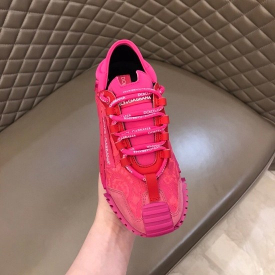 Top-down view of a Dolce & Gabbana fuchsia pink lace trainer displaying branded lacing