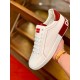 Handheld lateral view highlighting red stitching and heel detail on Dolce & Gabbana trainer in white and red