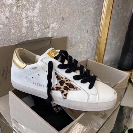 Golden Goose Trainer Side View in Box in white and gold Single Golden Goose white leather trainer with leopard star applique inside product box