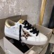 Golden Goose Trainer Side View in Box in white and gold Single Golden Goose white leather trainer with leopard star applique inside product box