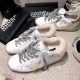 Golden Goose Super-Star White Leather Trainers Side Profile in white and grey Side profile view of white shearling-lined Golden Goose trainers on display in white and grey