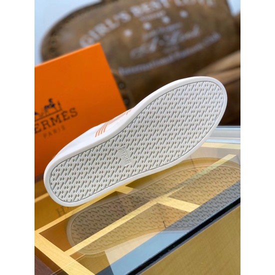 Outsole Tread View of White Leather Trainer in white and orange Underside view of white textured rubber tread sole with brand logo stamping in white and orange