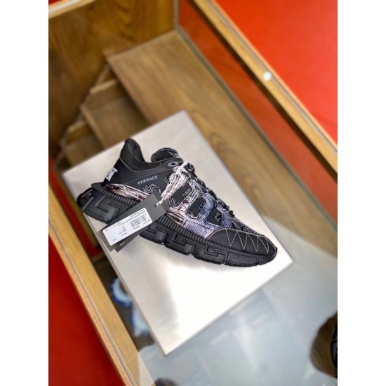 Versace Trigreca Black Trainer Side Angle Side view of a black Versace Trigreca trainer with attached product tags displayed on a stand