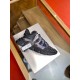 Versace Trigreca Black Trainer Side Angle Side view of a black Versace Trigreca trainer with attached product tags displayed on a stand