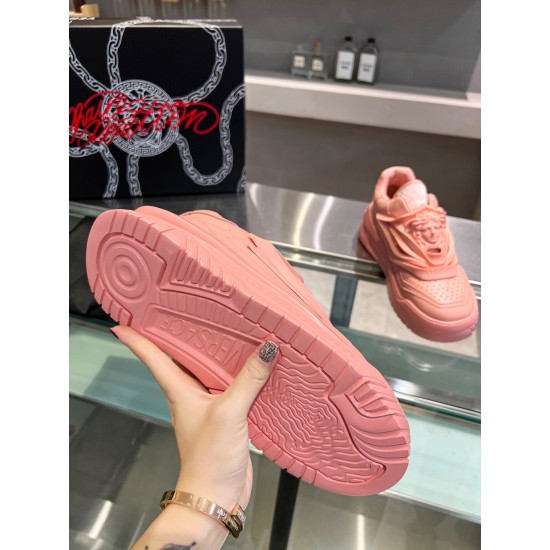 Bottom view showing the textured pink rubber outsole with embossed branding on the Versace trainer