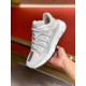 Versace Trigreca Low Top White Trainer Angle View in white and gold Hand holding Versace Trigreca Low Top White Trainer showing front panel and side profile in white and gold