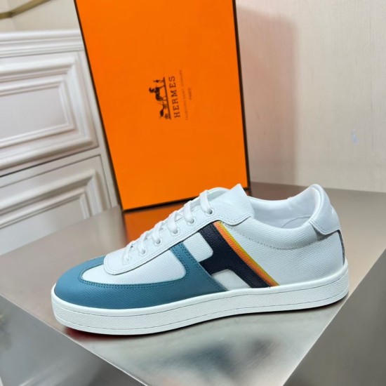 Side profile of Hermes Boomerang white trainer with blue accents and striping