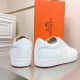 Hermes Boomerang White Leather Trainers Heel Detail Rear view of both Hermes Boomerang white leather trainers showing debossed heel counter logos.