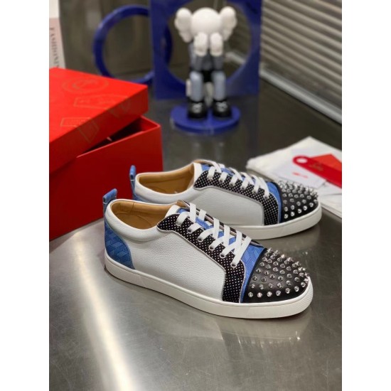 Christian Louboutin Louis Junior Spikes Orlato Pair View in white and blue Pair of white and blue Christian Louboutin Louis Junior Spikes Orlato low top trainers displayed on a tabletop