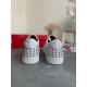 Rear view of Christian Louboutin white trainers displaying spike-embellished heel counters in white and silver