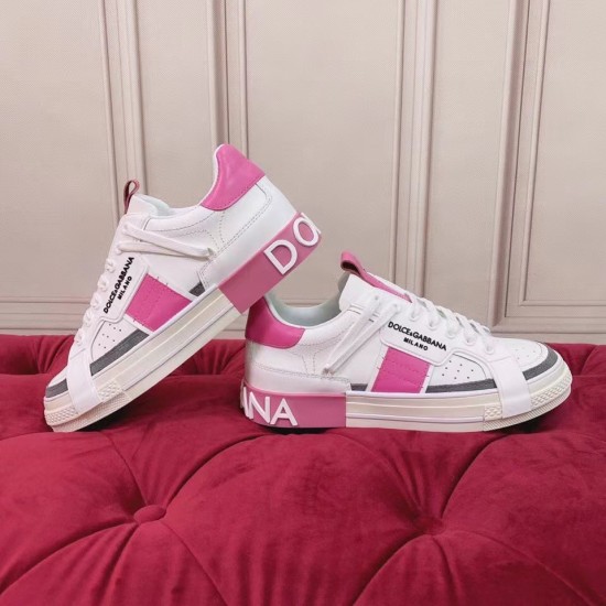 Dolce & Gabbana Custom 2.Zero Trainers Side Profile View in white and pink Side profile of white and pink Dolce & Gabbana Custom 2.Zero trainers on a red surface