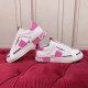 Dolce & Gabbana Custom 2.Zero Trainers Side Profile View in white and pink Side profile of white and pink Dolce & Gabbana Custom 2.Zero trainers on a red surface