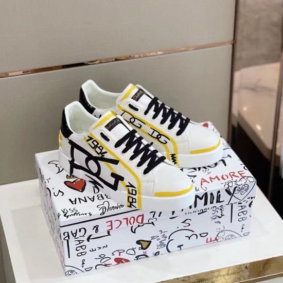 Dolce & Gabbana Portofino Printed White And Yellow Leather Trainers On Box Dolce & Gabbana Portofino Printed White And Yellow Leather Trainers resting on branded shoebox