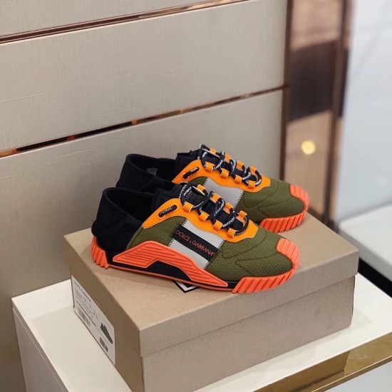 Dolce & Gabbana orange and green mesh trainers resting on top of their original shoe box