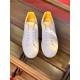 Top-Down View of White and Yellow Trainers Top-down view of white leather trainers with yellow lining and white laces