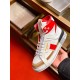 Hand holding a single Dolce & Gabbana Custom 2.Zero white and red high-top trainer showing side profile.