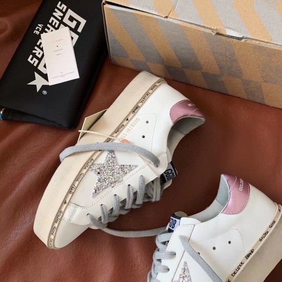 Top side view of Golden Goose Hi Star white trainer showing metallic pink heel tab in white and silver