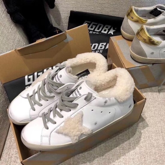 Golden Goose Super-Star White Trainers Boxed Pair in white and grey Pair of Golden Goose shearling lined white leather trainers resting in shoe box in white and grey