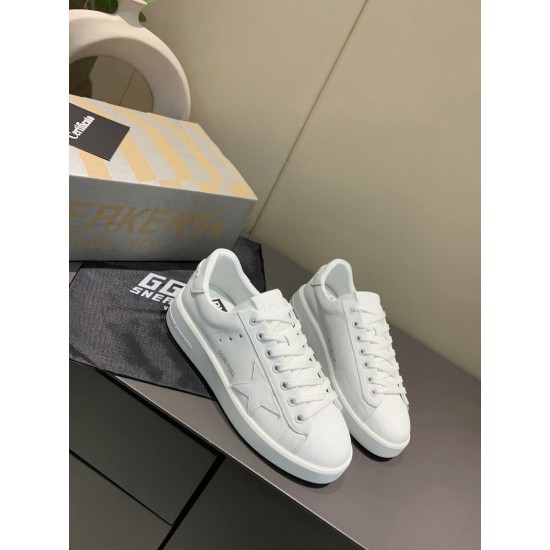 Angled pair view of Golden Goose Purestar white leather trainers on display