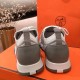 Rear view of both Hermes grey knit trainers showing the grey heel overlays