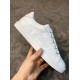 Single Hermes Avantage white leather trainer side profile held in hand