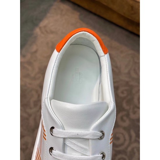 Insole and Lacing Detail on White Leather Trainer in white and orange Close-up top view showing white laces, metal eyelets, and orange heel tab inner collar