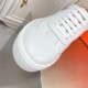 Close-up of the rounded toe box and white leather lacing system on Hermès trainer in white and orange
