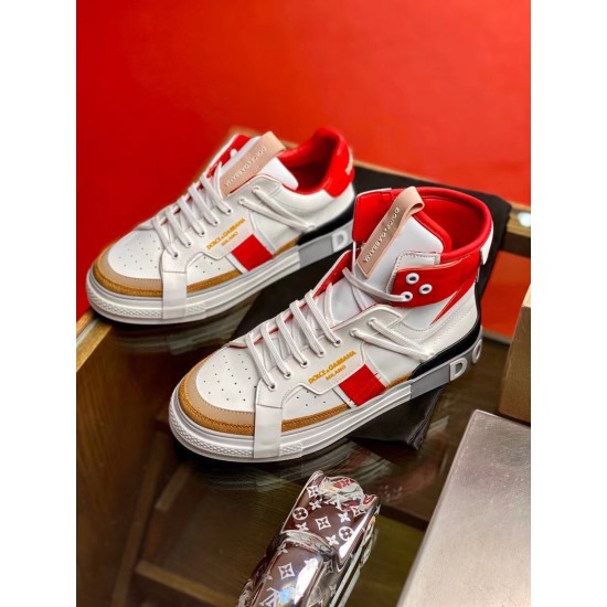 Dolce & Gabbana Custom 2.Zero white and red high-top trainers displaying panel details on a glass table.
