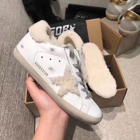 Golden Goose Super-Star Shearling Star Profile View in white and grey Lateral side view of white leather Golden Goose trainer showing shearling star and gold lettering in white and grey
