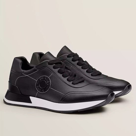 Hermes Drive Leather Low Top Trainers Black Side View in black and white Hermes Drive Leather Low Top Trainers Black side profile view showing circular motif and white soles