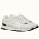 White Trail Leather Low Top Trainers Side View in white and black Pair of white leather Trail low top trainers with black heel clip accents shown at a three-quarter angle.
