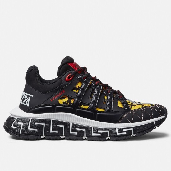 Versace Trigreca Black Barocco Trainers Side View in black and yellow Side profile view of Versace Trigreca black low top trainers featuring yellow Barocco print and white Greca midsole